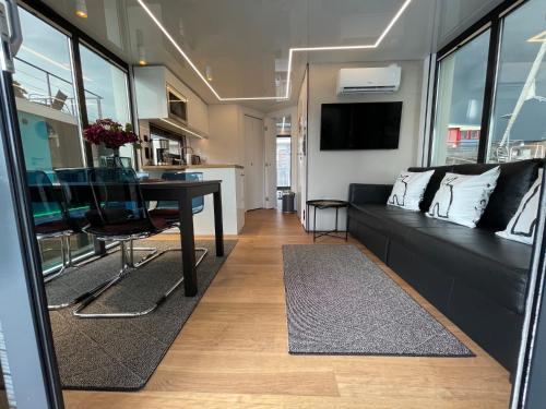 a living room with a black couch and a table at La Mare Resort in Gothenburg