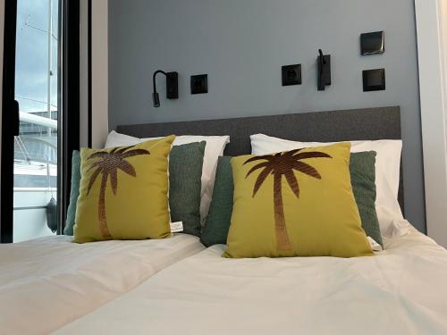 a bedroom with a bed with two palm trees on it at La Mare Resort in Gothenburg