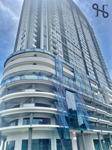 a tall building with a sign on the side of it at Homesuite' Home at Jesselton Quay in Kota Kinabalu