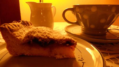 a piece of cake on a plate next to a cup at Antica Casa Dei Rassicurati in Montecarlo