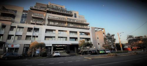 a large white building on the side of a street at beautiful apartment 100mts near the beach in Port Melbourne in Melbourne
