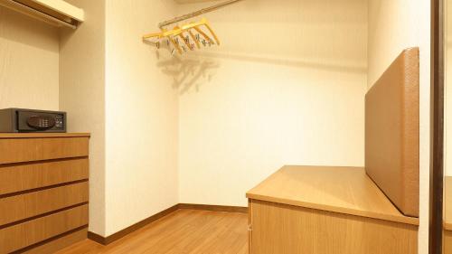 a room with a kitchen with a refrigerator and a counter at Arima Onsen Taketoritei Maruyama in Kobe