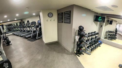 a gym with rows of treadmills and weights at Holiday Inn Tuxpan - Convention Center by IHG in Tuxpan de Rodríguez Cano