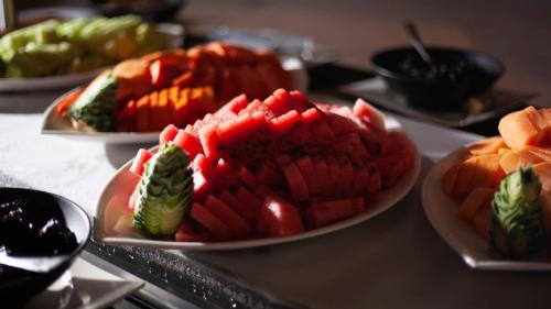 three plates of food on a table with fruit at Holiday Inn Tuxpan - Convention Center by IHG in Tuxpan de Rodríguez Cano