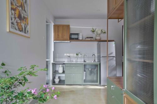 a kitchen with a sink and a refrigerator at M Village The Tropic in Ho Chi Minh City