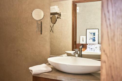 a bathroom with a sink and a large white tub at Marrakech Villa Dar Belkiss in Tameslouht