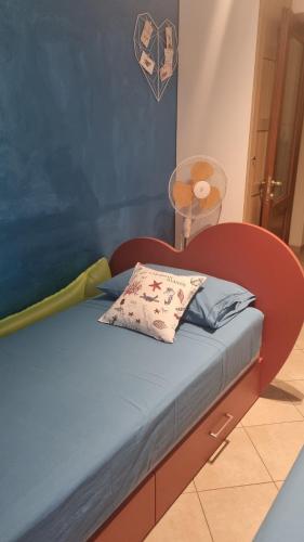 a bed with a red bed frame with a pillow on it at Civico69 in Rapallo