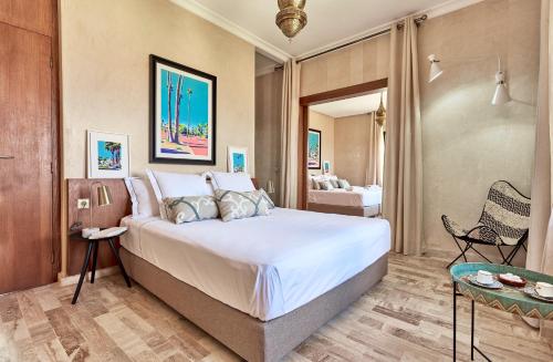 a bedroom with a large bed in a room at Marrakech Villa Dar Belkiss in Tameslouht