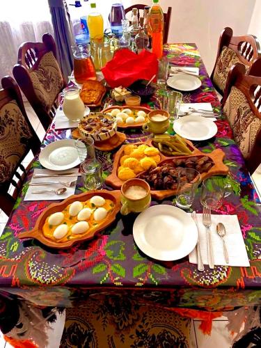 a table with plates of food on it at Casa Grai Moroșănesc in Breb