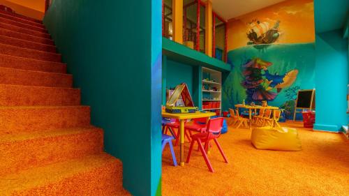 a room with a staircase and a table and chairs at Hotel AquaCity Riverside in Poprad