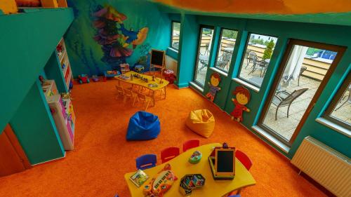 an overhead view of a childs play room with a table and chairs at Hotel AquaCity Riverside in Poprad