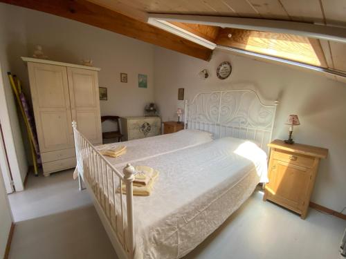 a bedroom with a white bed and a window at Maison de vacances village Océlandes in Saint-Julien-en-Born