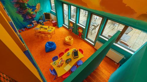 an overhead view of a play room with a table and chairs at Hotel AquaCity Mountain View in Poprad