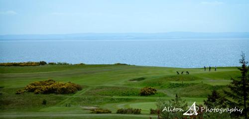 a group of people on a golf course near the ocean at Old Manor Hotel in Lundin Links