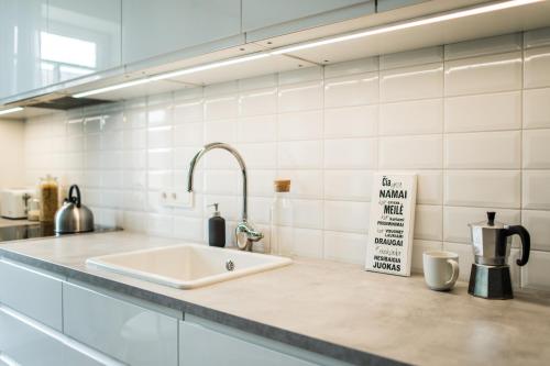 a kitchen counter with a sink in a kitchen at Stylish apartment in the heart of Kaunas Old Town in Kaunas