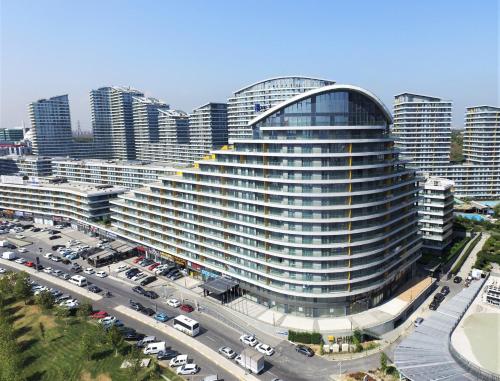 a large building with cars parked in a parking lot at The Superior Living Batışehir in Istanbul