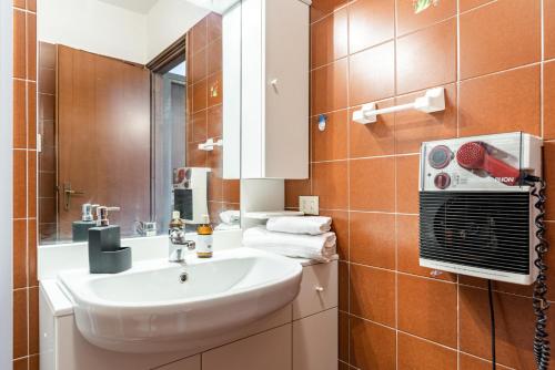 a bathroom with a sink and a mirror at Nesso APT with Private Parking & Shared Pool! in Nesso