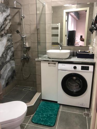 a bathroom with a washing machine and a sink at central square in Kutaisi