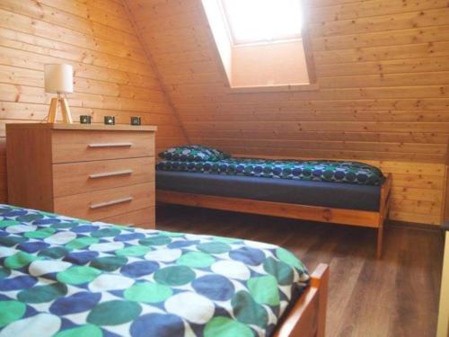 a bedroom with a bed and a dresser in a room at NADMORSKI RESORT in Niechorze