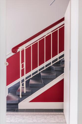 a red and white staircase in a room at Die Sonne Nollingen in Nollingen