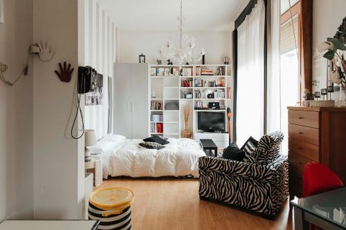 een witte slaapkamer met een bed en een stoel bij Il Loggione in Enna
