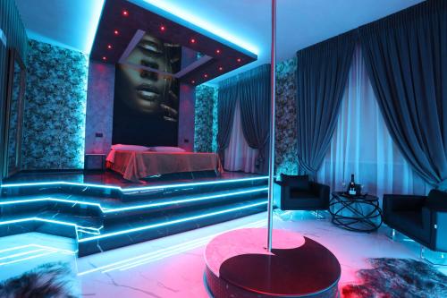 a bedroom with a bed with a black face on the wall at Alcova Suite&Relax in Eboli