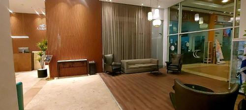 a lobby with a waiting room with a couch and chairs at 8 Hotel Apartment Short Time TLV BAT YAM in Bat Yam