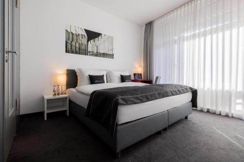 een slaapkamer met een groot bed en een raam bij Select Hotel Berlin Gendarmenmarkt in Berlijn