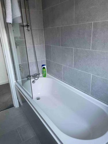 a bathroom with a white bath tub and a shower at Newly refurbished one bedroom apartment in Preston