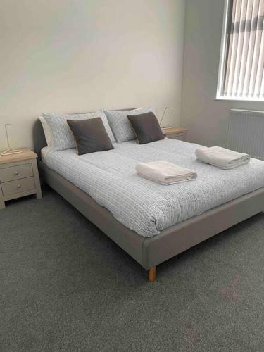 a bedroom with a bed with two pillows on it at Newly refurbished one bedroom apartment in Preston