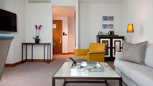 a living room with a couch and a table at InterContinental London - The O2 in London