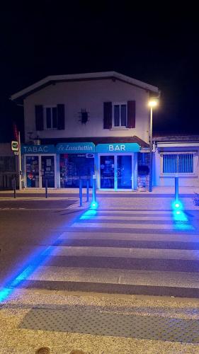 a building with blue lights in front of a street at LE ZANCHETTIN in Mont-de-Marsan
