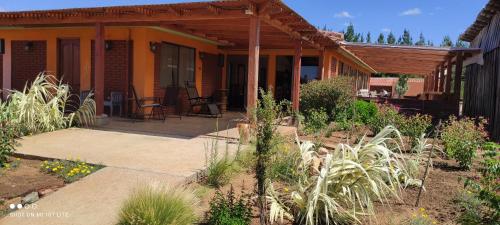 a house with a porch and a patio at Willy's Country Club Cauquenes in De Cauquenes