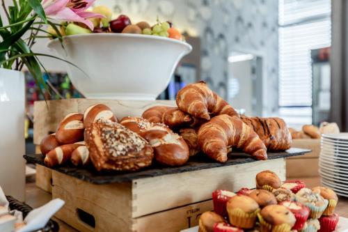 a bunch of pastries and croissants on a table at Garner Hotel Berlin - Spandau by IHG in Berlin