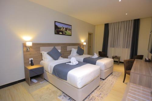 Postel nebo postele na pokoji v ubytování Triple E Hotel and Spa
