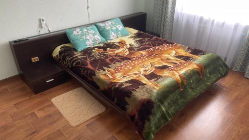 a bedroom with a bed with a painting of a deer at Квартира в новому будинку in Kyiv