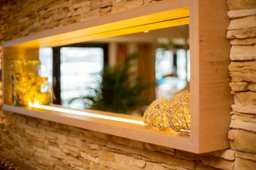 a wooden shelf on a brick wall with a window at Pension La Mamma in Aschach an der Donau