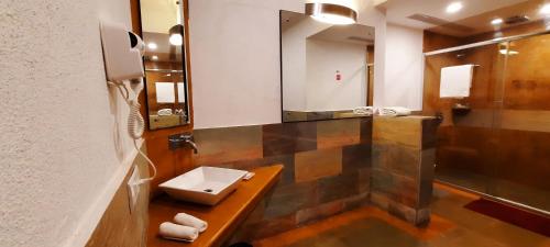 a bathroom with a sink and a mirror at Treasure Island Resorts Lonavala in Lonavala