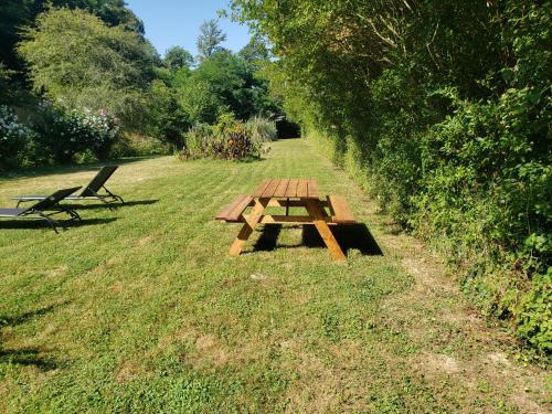a picnic table sitting in the grass in a field at Meublé de tourisme FONTARRABIE in Saint-Jacques