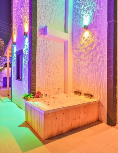 a large bathroom with a tub with purple lighting at Villa Grando 2 in Kas