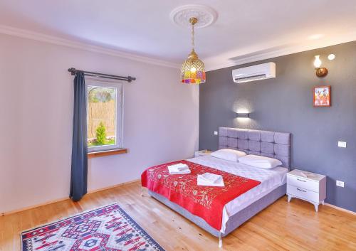 a bedroom with a bed and a window and a rug at Villa Grando 2 in Kas