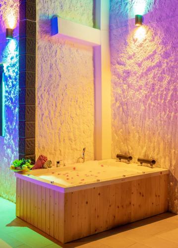 a large bath tub in a room with purple lights at Villa Grando 2 in Kas