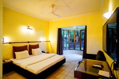 a bedroom with a large bed and a window at Treasure Island Resorts Lonavala in Lonavala