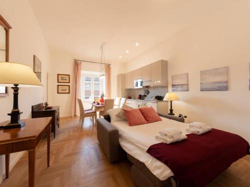 a bedroom with a large bed and a kitchen at The Best Rent - Bright apartment near Isola Tiberina in Rome