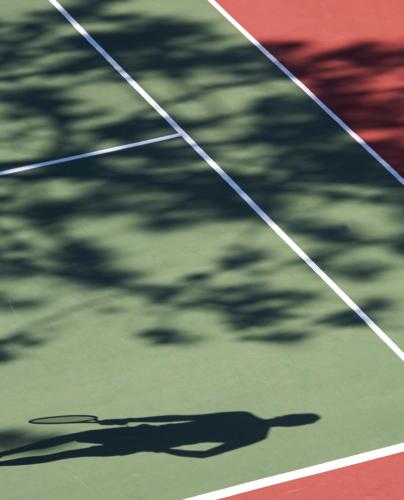 a shadow of a person on a tennis court at Hotel Porto Mare - PortoBay in Funchal