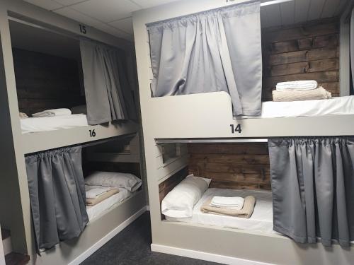 a room with three bunk beds in it at Albergue As Pozas Termais in Caldas de Reis