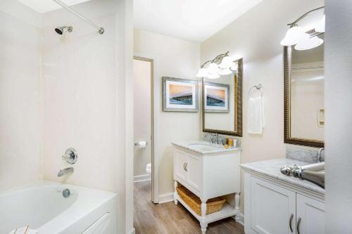 een witte badkamer met een wastafel en een bad bij Ellington at Wachesaw Plantation East a Ramada by Wyndham in Myrtle Beach