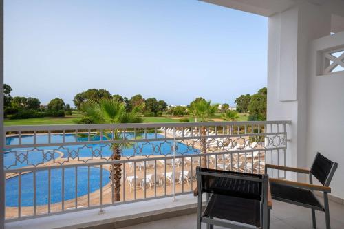 a balcony with a view of a swimming pool at Radisson Blu Resort, Saidia Garden in Saidia 