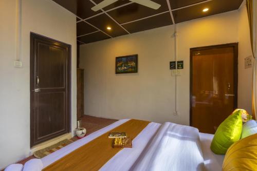 a bedroom with a bed with a cross on it at Zostel Homes Harabhag, Jogindernagar in Bīr