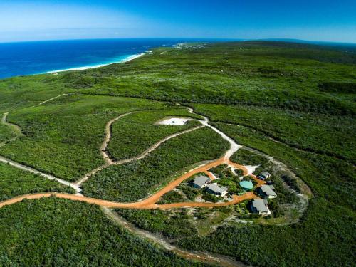 an aerial view of a field with the ocean at Redgate Beach Escape in Witchcliffe